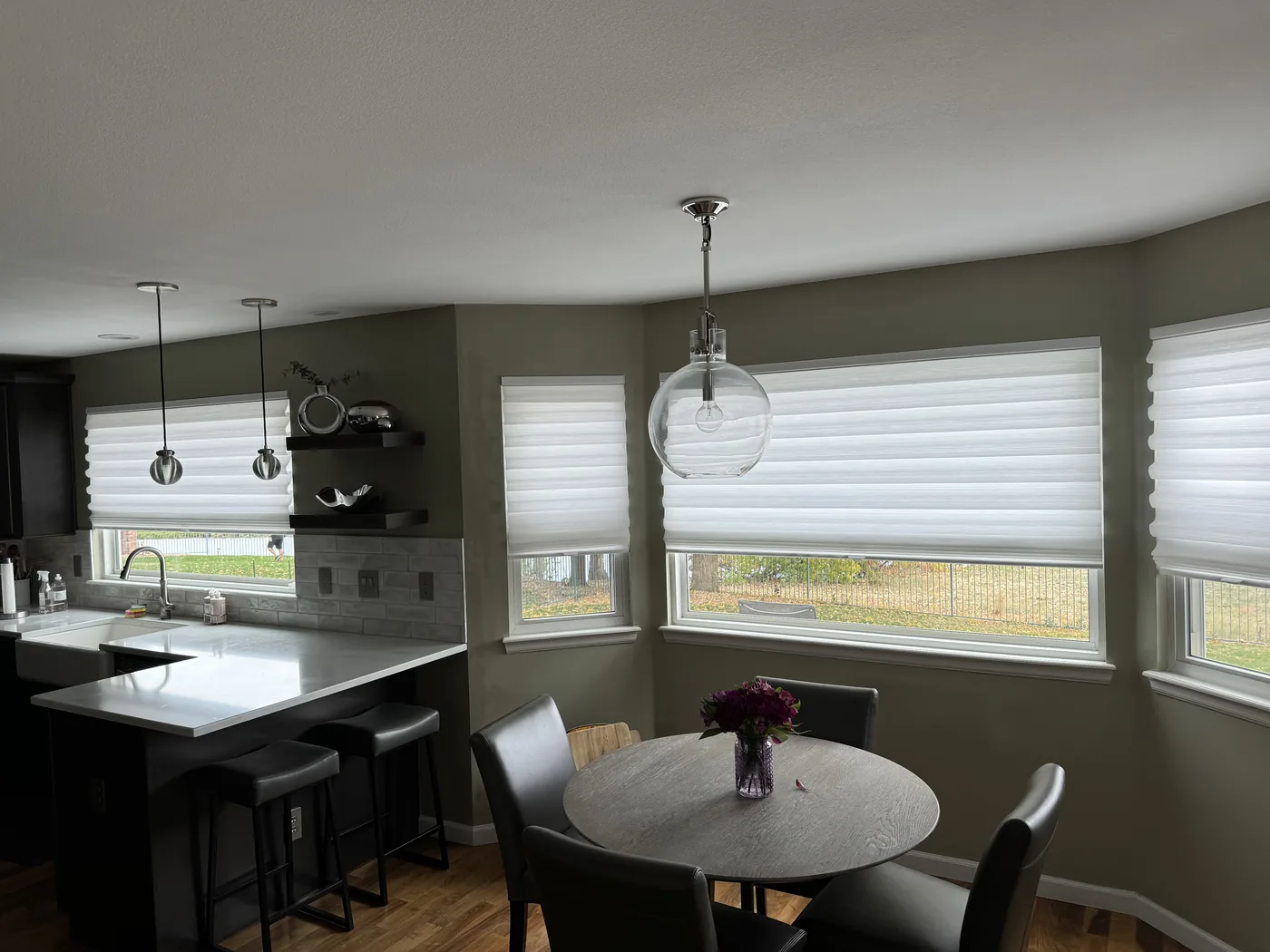 White Roman shades installed in a modern kitchen and dining room, custom window treatments by Howard's Draperies, Boulder Colorado