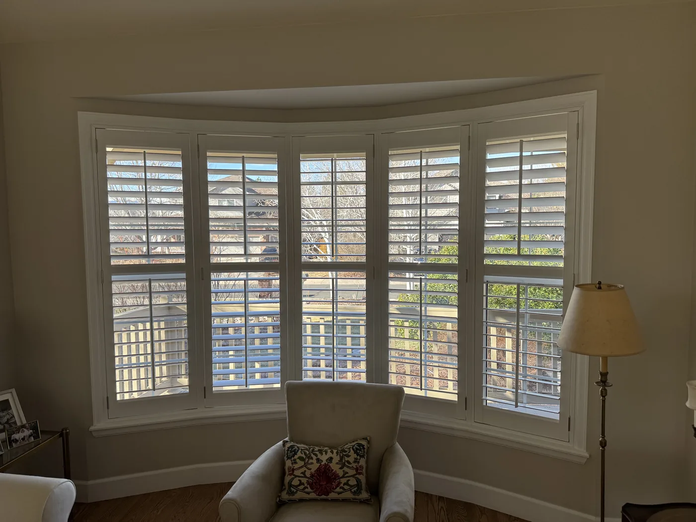 Custom white plantation shutters on a five-panel bay window, Howard's Draperies Boulder Colorado